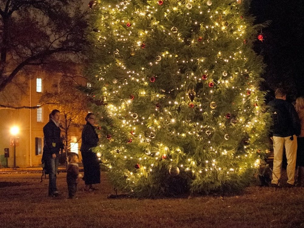 The Christmas tree on the Horseshoe was lit Tuesday evening, but the annual celebration was moved indoors.
