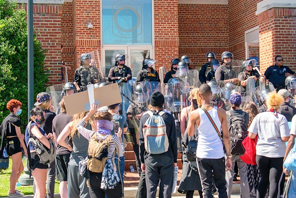 <p>Protesters gathered in front of the Columbia Police Department. Armed police officers lined the steps of the building.&nbsp;</p>