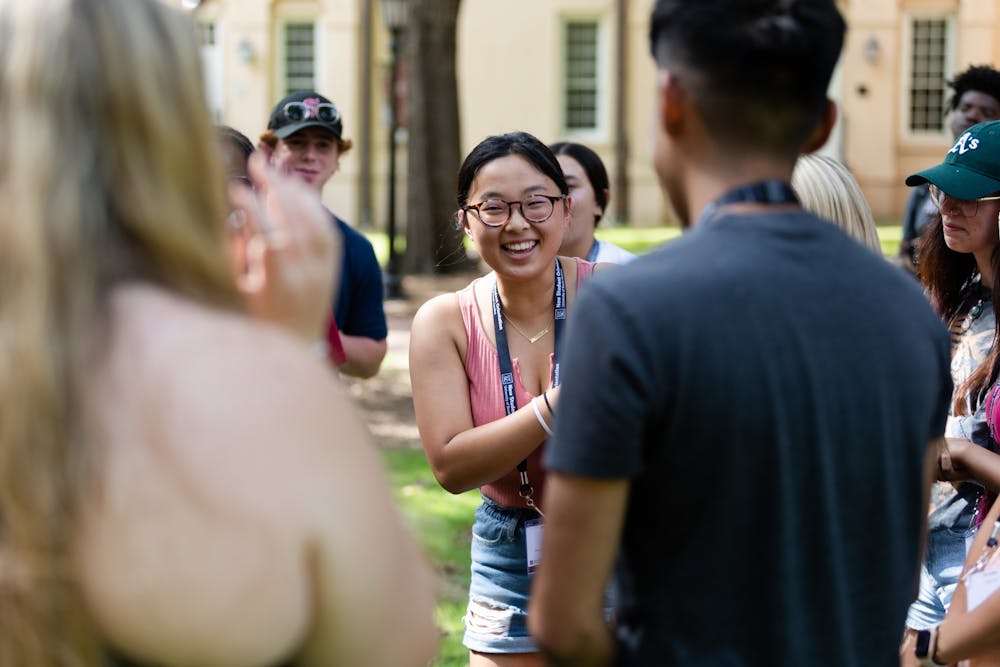 <p>A first-year student laughs while playing a game of rock paper scissors on the horseshoe during an orientation session on July 20, 2022. Before starting their first semester at USC, freshmen students attend a two-day program to introduce them to campus and college life.&nbsp;</p>