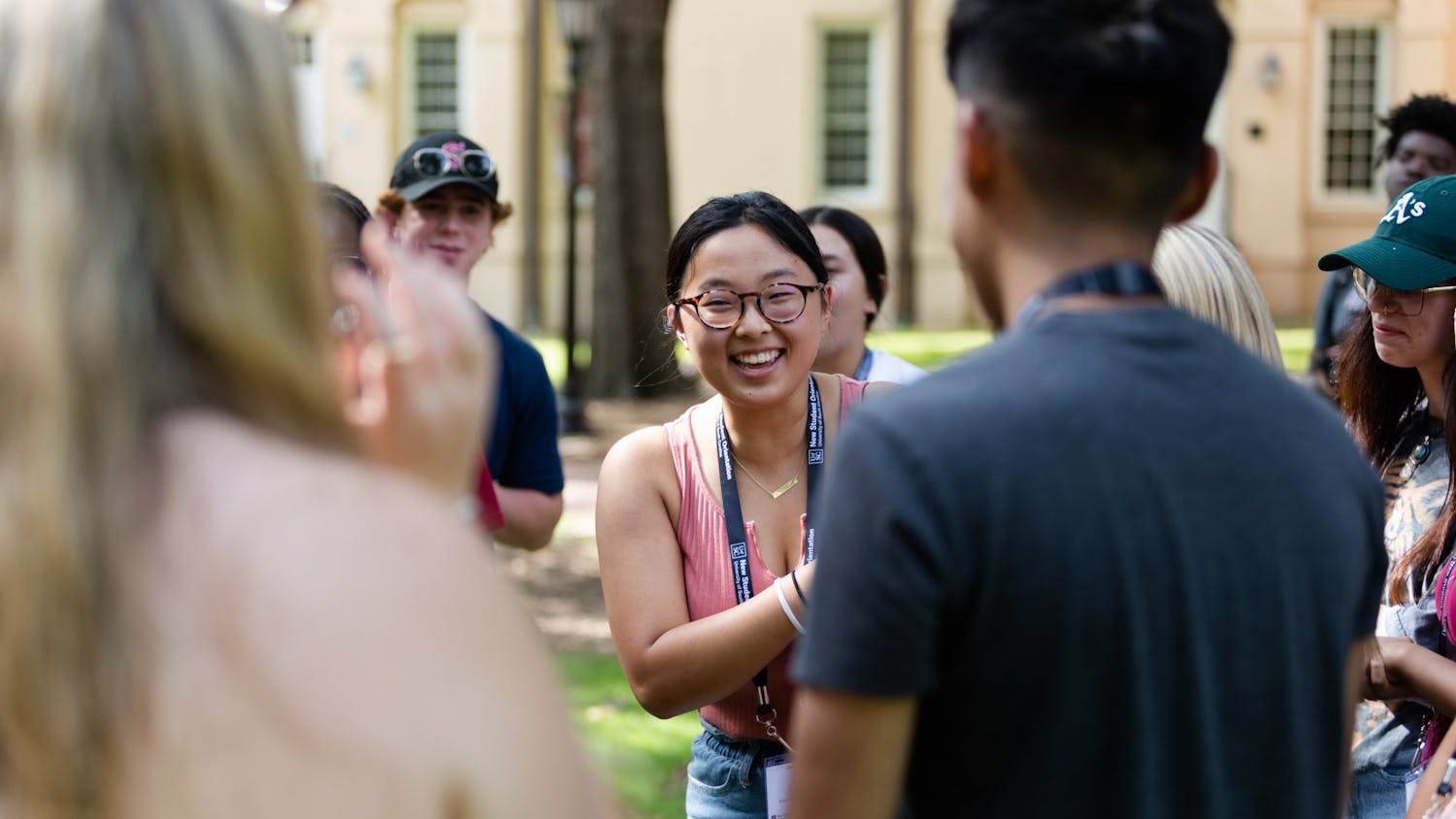 A first-year student laughs while playing a game of rock paper scissors on the horseshoe during an orientation session on July 20, 2022. Before starting their first semester at USC, freshmen students attend a two-day program to introduce them to campus and college life.&nbsp;