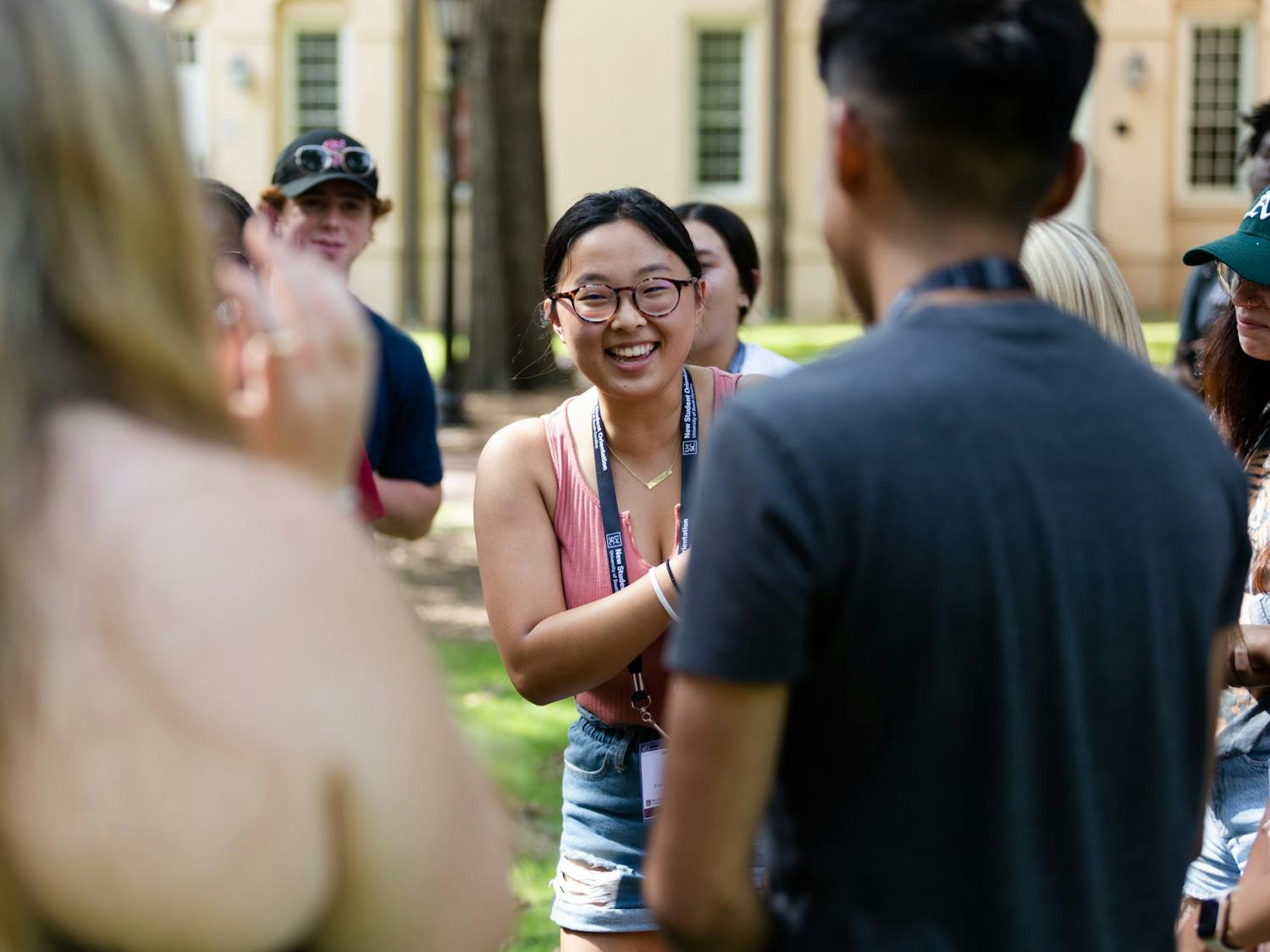 A first-year student laughs while playing a game of rock paper scissors on the horseshoe during an orientation session on July 20, 2022. Before starting their first semester at USC, freshmen students attend a two-day program to introduce them to campus and college life. 