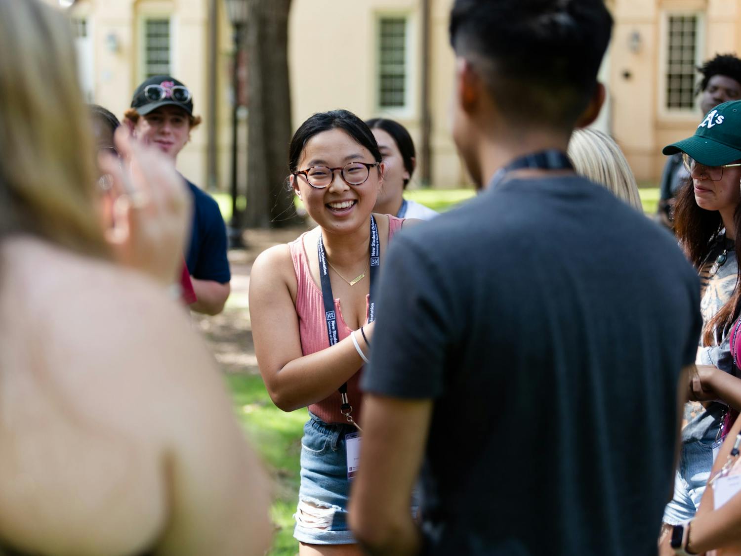 A first-year student laughs while playing a game of rock paper scissors on the horseshoe during an orientation session on July 20, 2022. Before starting their first semester at USC, freshmen students attend a two-day program to introduce them to campus and college life.&nbsp;