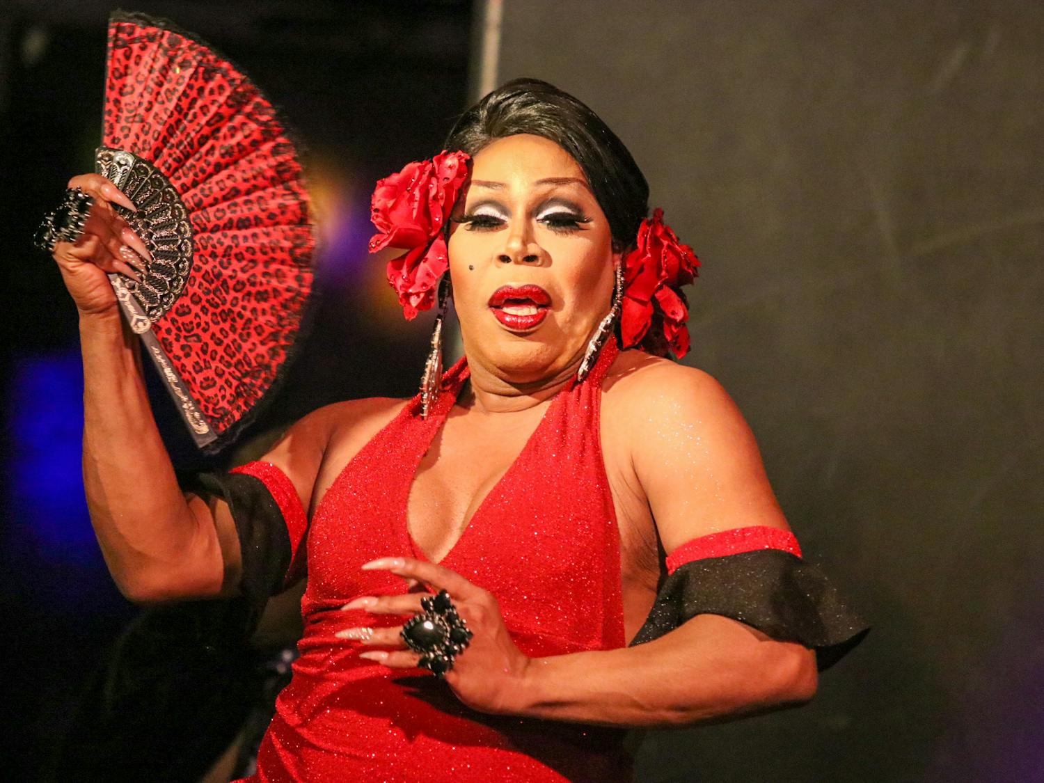 Dorae Saunders takes a break from hosting the drag show at PT's 1109 to perform her own set on Sept. 10, 2022. Decked in red from head to toe, she accented her romantic performance with a cheetah print fan.&nbsp;