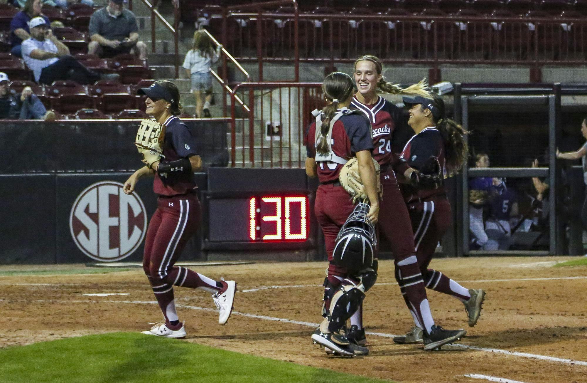 Junior pitcher Nealy Lamb prepares to throw at the softball game against Furman at the Carolina Softball Stadium on Oct. 17, 2025. Her teammates cheer her on as they call out her number, “24.”