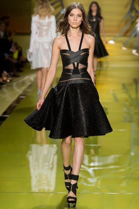	The bondage top on this dress at Versace balances the fullness of the almost velvet skirt.