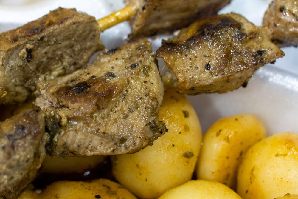 Closeup of Greek dish Souvlaki resting atop small potatoes during the first night of the 2022 Greek festival, Sept. 11, 2022. Vendors, local businesses, and members of the Columbia community gathered for a night of dancing, food, and congregation for the 2022 Greek Fest held on 1931 Sumter Street in Columbia, SC.