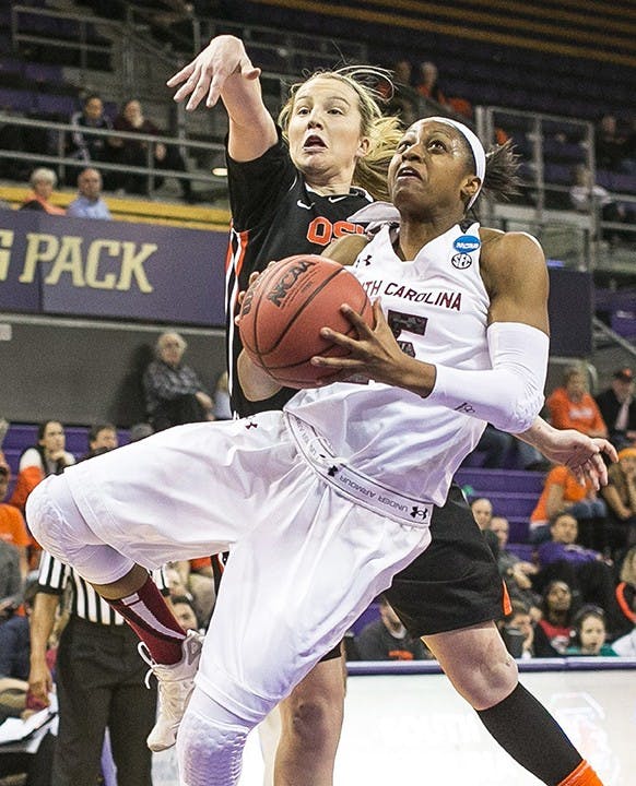 South Carolina&apos;s Tiffany Mitchell is fouled in the lane by Oregon State&apos;s Ali Gibson. The South Carolina Gamecocks defeated the Oregon State Beavers, 78-69, during the second round of the NCAA Tournament on Tuesday, March 25, 2014, in Seattle. (Dean Rutz/Seattle Times/MCT)