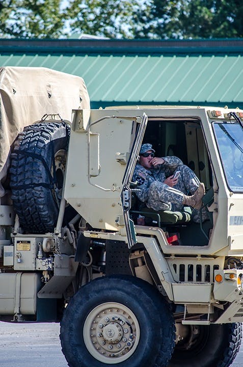 Member of the National Guard takes a moment to rest at the Bi Lo parking lot on Forest Drive, October 6. 