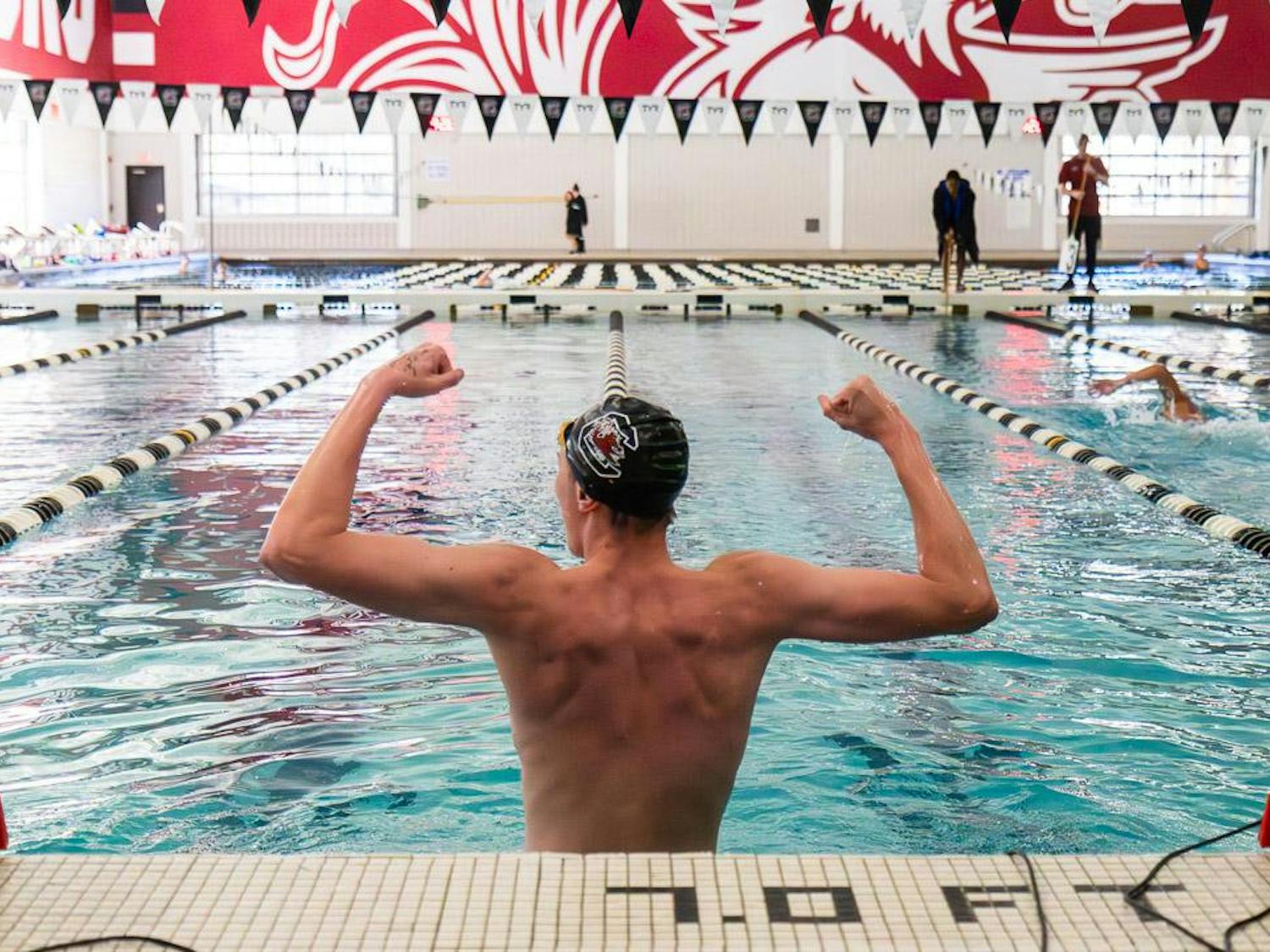 Freshman Connor Fry flexes in celebration after finishing in first place of the first heat of the men’s 1000-meter freestyle against Duke on Jan. 20, 2024 at the Carolina Natatorium. The Gamecocks men’s swim and dive team defeated the Blue Devils 204-91.