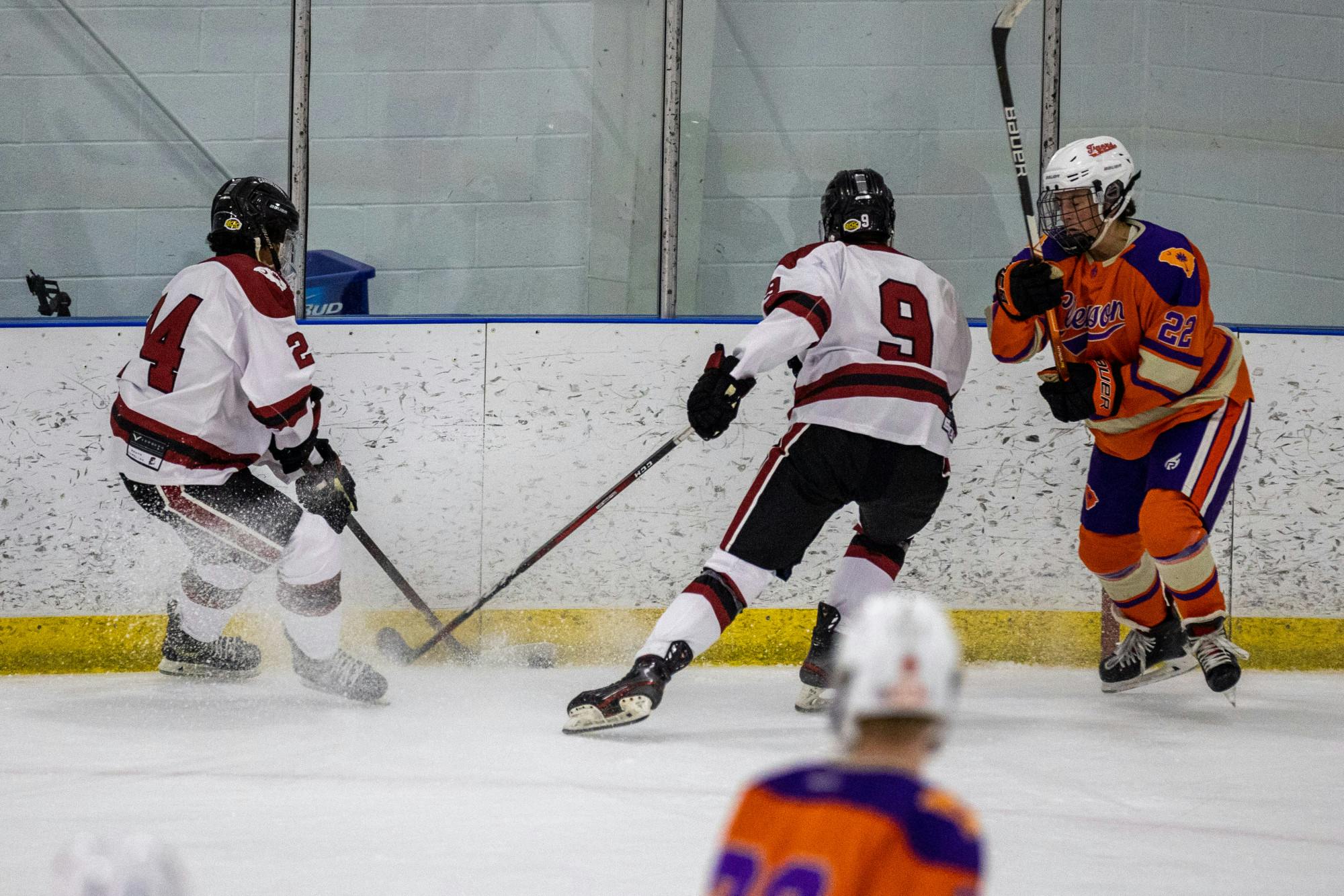 Sophmore wingers Marco Pineda and Brody Smojice attempt to steal control of the puck from a Clemson opponent during a match on Nov. 11, 2022. The two players completed a fast stop to regain possession after a Clemson steal.