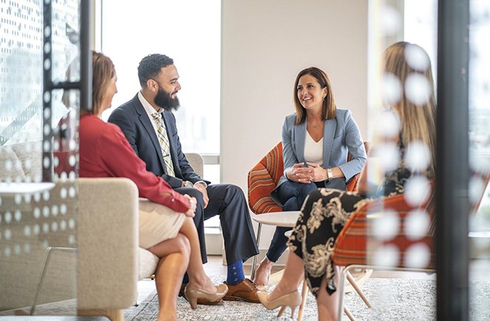 From left, Baker McKenzie human resources director Renee Agler, new business intake manager Samuel Demian, executive director Jamie Lawless, and finance director Nikki Rogers chat in one of the firm&apos;s casual breakout spaces at its new business center in Tampa.  Baker McKenzie