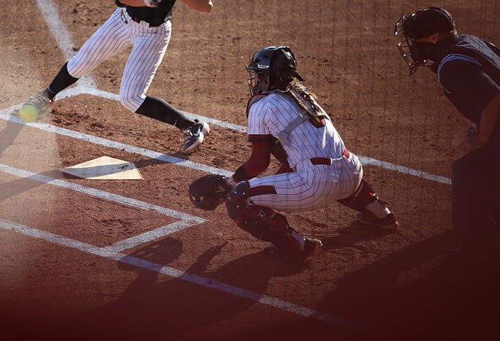 &nbsp;Junior catcher Jordan Fabian prepares to catch the ball while her teammate prepares to pitch.&nbsp;