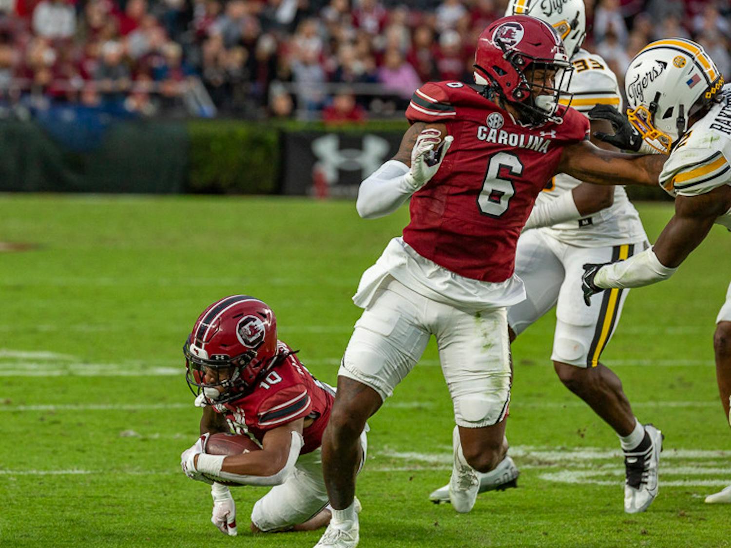 Fifth-year Josh Vann (on right) blocks a Missouri defender as senior wide receiver Ahmarean Brown (on left) catches the ball during the South Carolina and Missouri matchup on Oct. 29, 2022. South Carolina had a total of 203 total yards, and Missouri had 367.