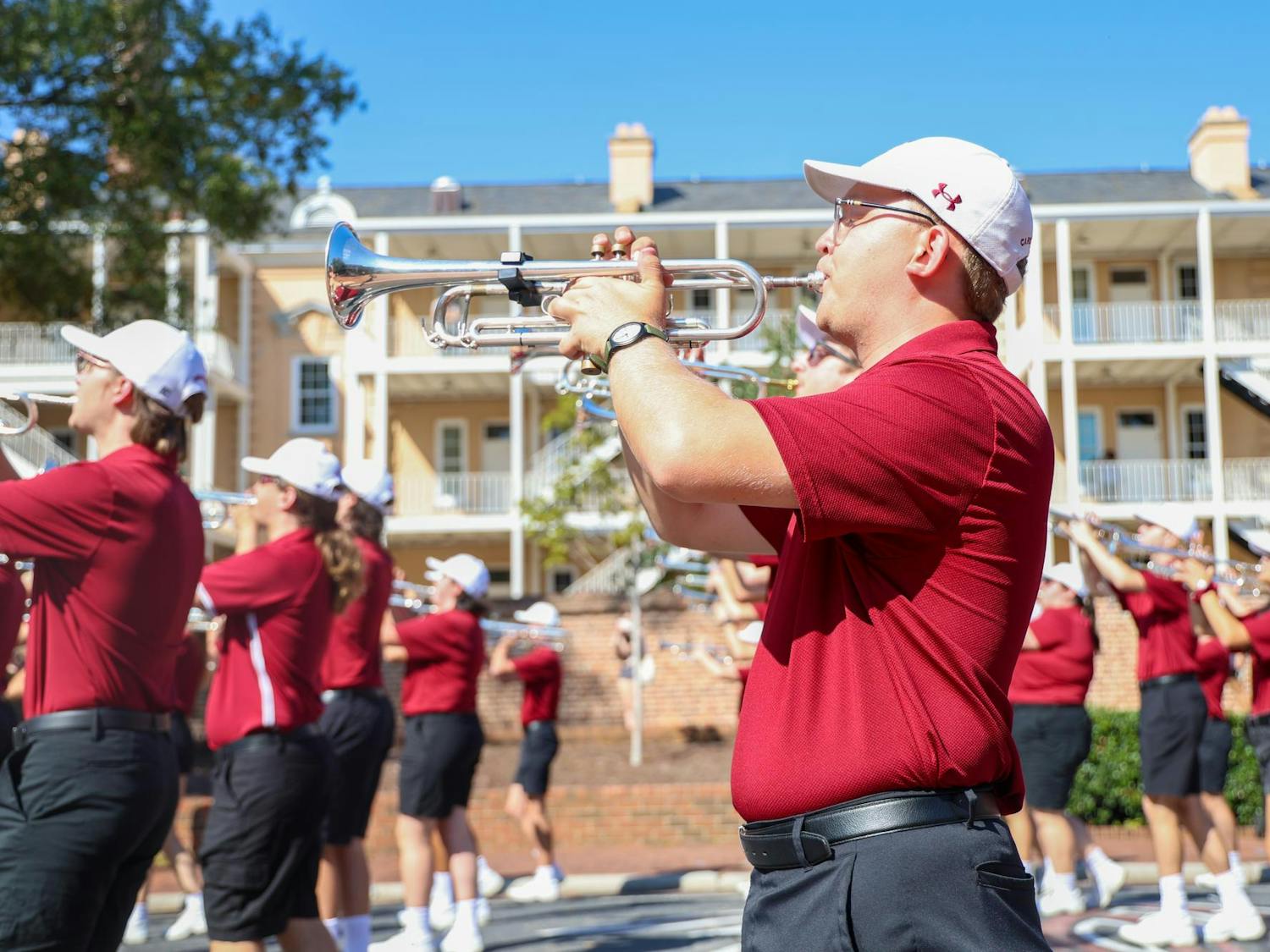A member of the Carolina Band plays the trumpet while marching down Greene Street on Oct. 26, 2024. The band, also known as the "Mighty Sound of the Southeast," will march in the Macy's Thanksgiving Day Parade this year for the first time in its 104 year history.