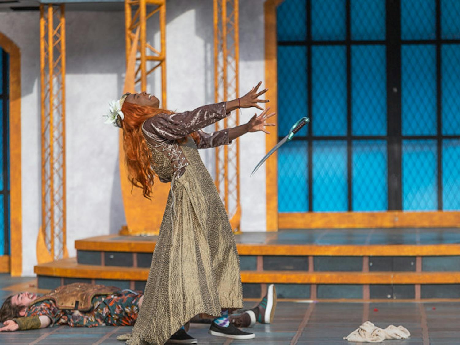 The character Flute, portrayed by second-year theatre student Phillip Parker acts out being fatally wounded by a sword during the final act of "A Midsummer Night's Dream" on Oct. 9, 2022. &nbsp;The character Flute is performing the tragedy of Pyramus and Thisbe to the Duke of Athens in this final scene of the play.
