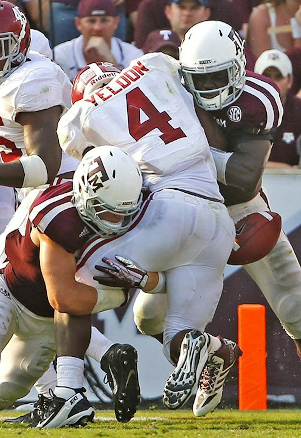 Texas A&amp;M Aggies linebacker Brett Wade, left, and linebacker Steven Jenkins, right, force a fumble by Alabama Crimson Tide running back T.J. Yeldon during the second half at Kyle Field in College Station, Texas, Saturday, September 14, 2013. Alabama defeated Texas A&amp;M, 49-42. (G.J. McCarthy/Dallas Morning News/MCT)