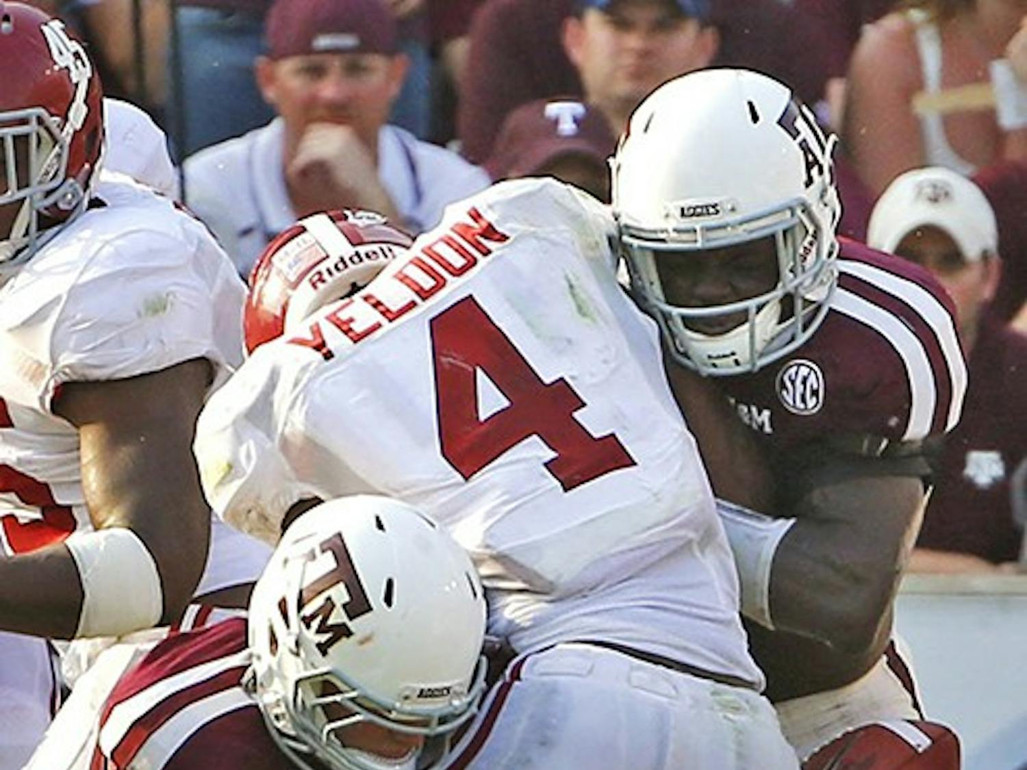 Texas A&amp;M Aggies linebacker Brett Wade, left, and linebacker Steven Jenkins, right, force a fumble by Alabama Crimson Tide running back T.J. Yeldon during the second half at Kyle Field in College Station, Texas, Saturday, September 14, 2013. Alabama defeated Texas A&amp;M, 49-42. (G.J. McCarthy/Dallas Morning News/MCT)