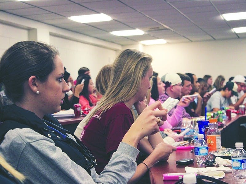 Students in the “Super Bowl of Advertising” class gather in the Carolina Coliseum to judge commercials shown during the game Sunday night.