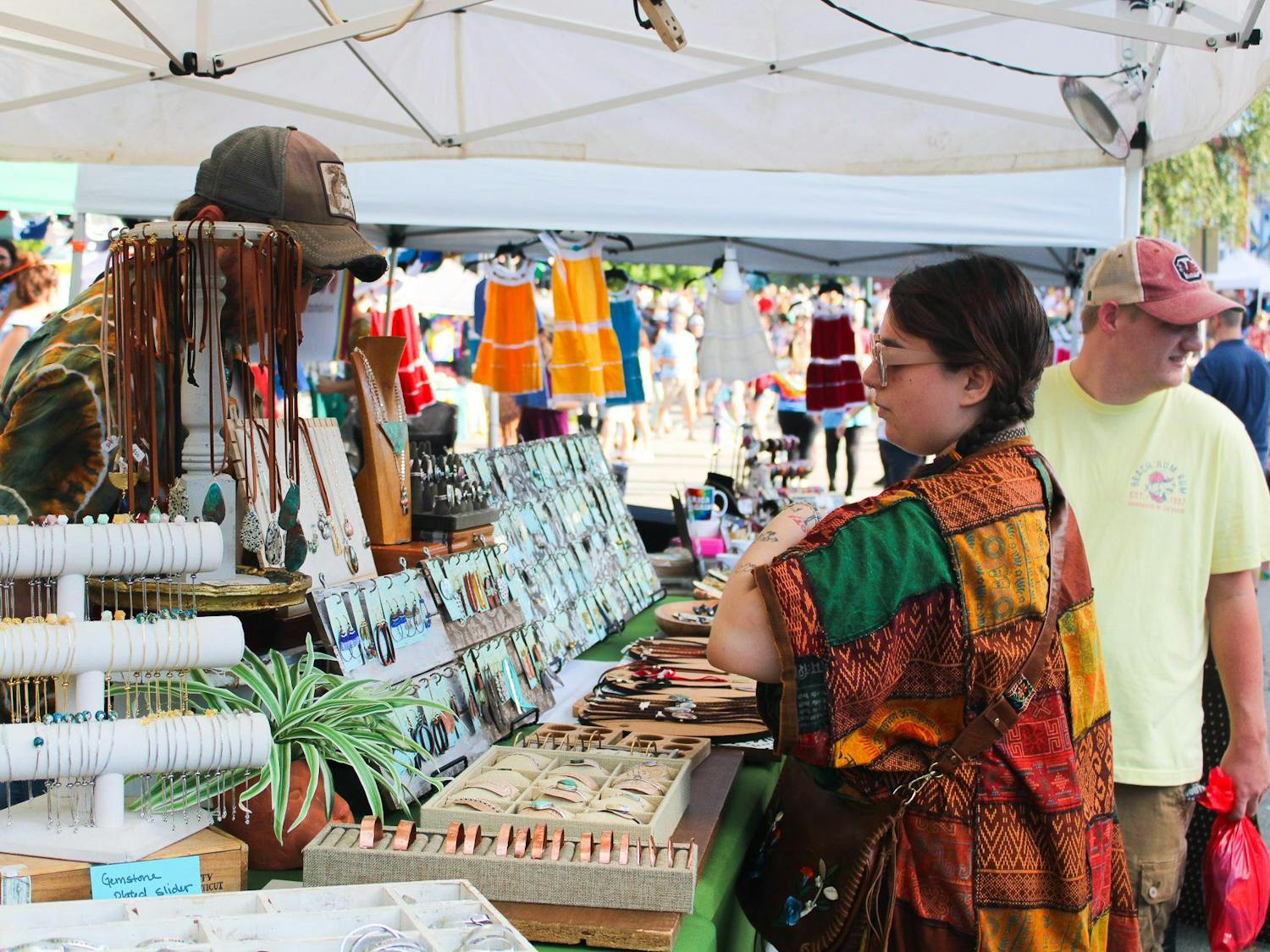 A vendors at JerryFest sells goods to a patron on Oct. 1, 2023. JerryFest is an annual Grateful Dead and Jerry Garcia tribute festival that is held in Five Points.