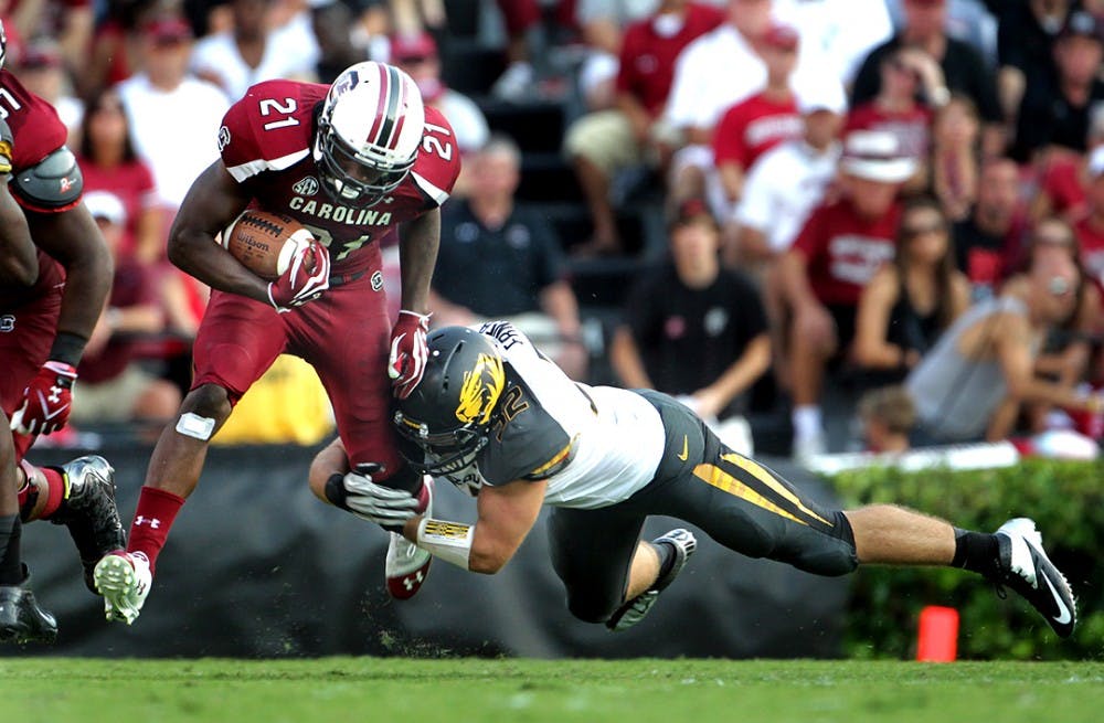 University of South Carolina&apos;s Marcus Lattimore (21) breaks a tackle by Missouri&apos;s Will Ebner in the fourth quarter at William-Brice Stadium in Columbia, South Carolina, Saturday, September 22, 2012. South Carolina defeated Missouri, 31-10. (C. Aluka Berry/The State/MCT)