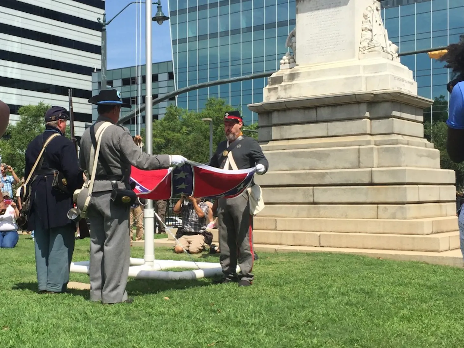 Confederate flag supporters in Civil War re-enactment uniforms ceremonially raise the battle flag at a rally on Statehouse grounds on July 10, 2016.