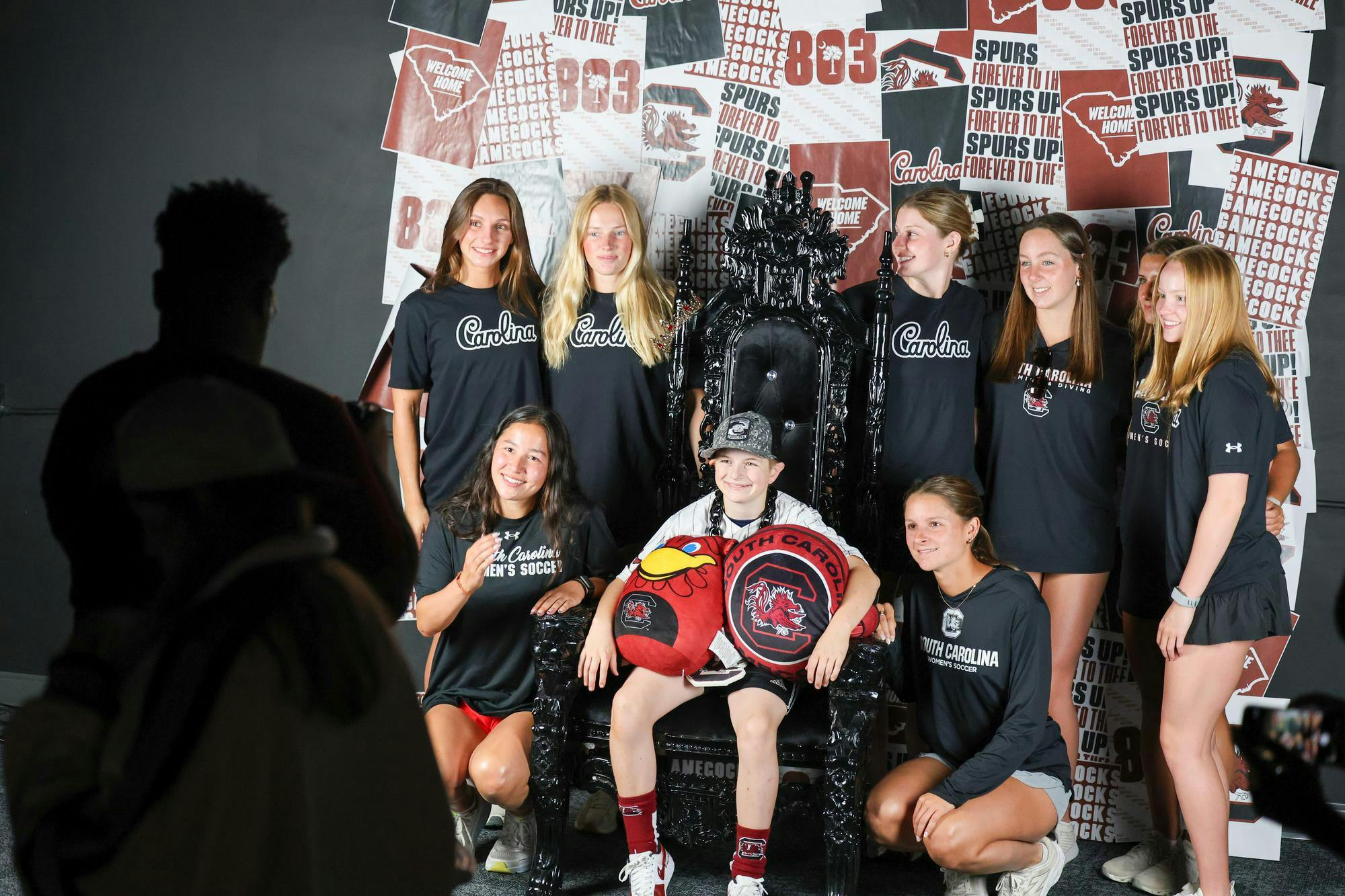 Lexington resident Gabriel Lyons poses for a media day photoshoot with members of the Collegiate Dream Team on April 25, 2026. The student athletes are members of the USC chapter of Dream on 3, which plans dream days with kids living with learning or developmental disabilities.