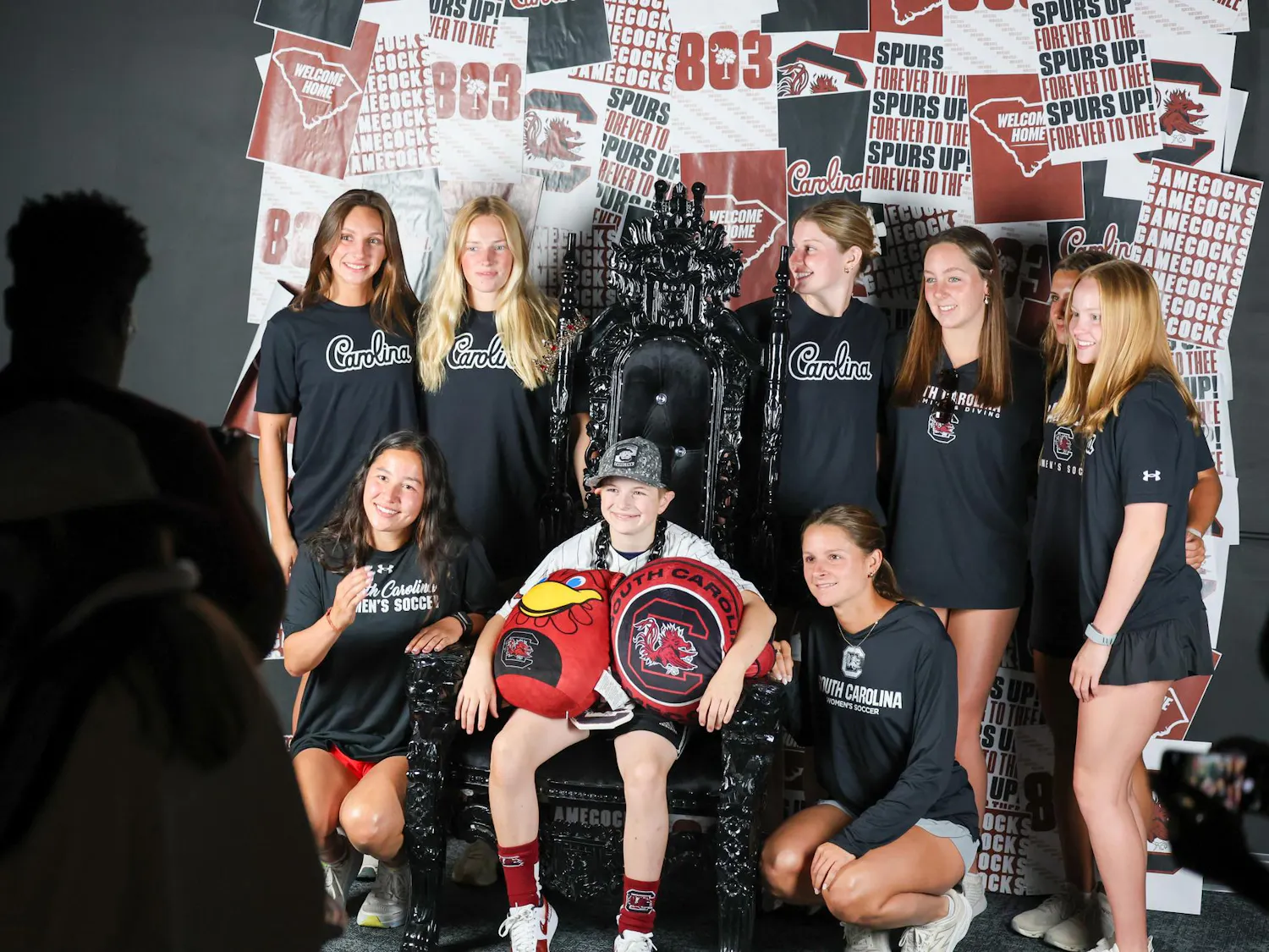 Lexington resident Gabriel Lyons poses for a media day photoshoot with members of the Collegiate Dream Team on April 25, 2026. The student athletes are members of the USC chapter of Dream on 3, which plans dream days with kids living with learning or developmental disabilities.