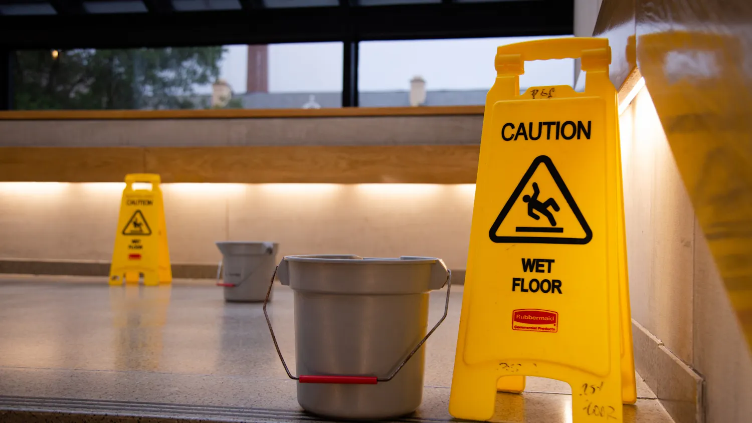 A picture of caution signs and buckets on the steps of the Russell House on July 5, 2022. The buckets were placed to catch water leaking from the ceiling due to heavy rain. 