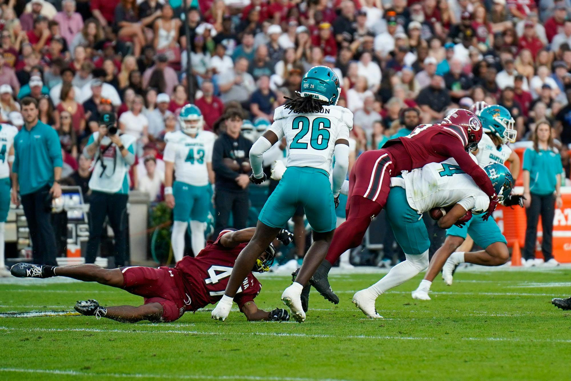 Redshirt junior defensive back Gerald Kilgore (right, garnet jersey) tackles a Coastal Carolina player at Williams-Brice Stadium on Nov. 22, 2025. The Gamecocks' defense allowed 46 rushing yards this game.