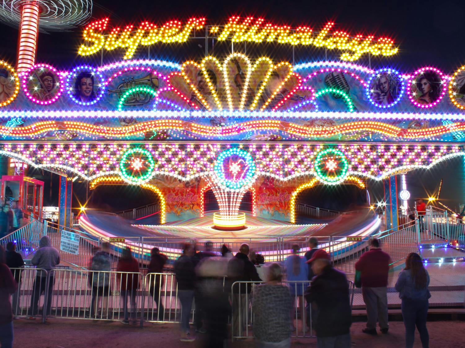 The Super Himalaya, a ride that features loud music and a wavy, speedy spinning motion, sits in the fairgrounds on Oct. 23, 2022. The structure moves riders forward and backwards at high speeds, making fair attendees dizzy and in risk of losing their lunch.&nbsp;