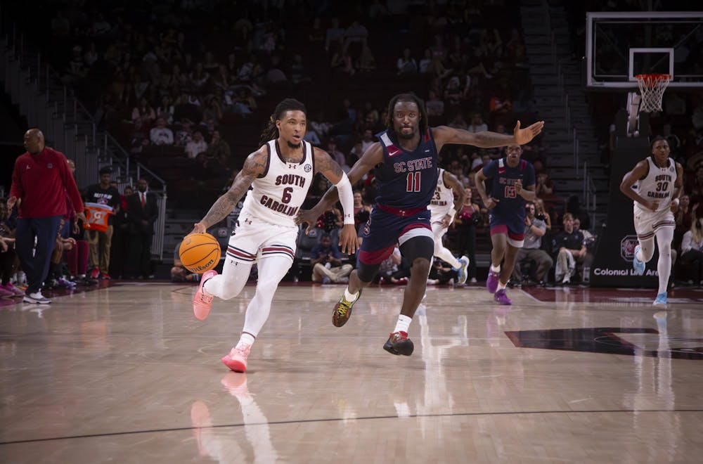 <p>FILE - Senior guard Jamarii Thomas dribbles the ball past a South Carolina State University defender at Colonial Life Arena on Nov. 8, 2024.</p>