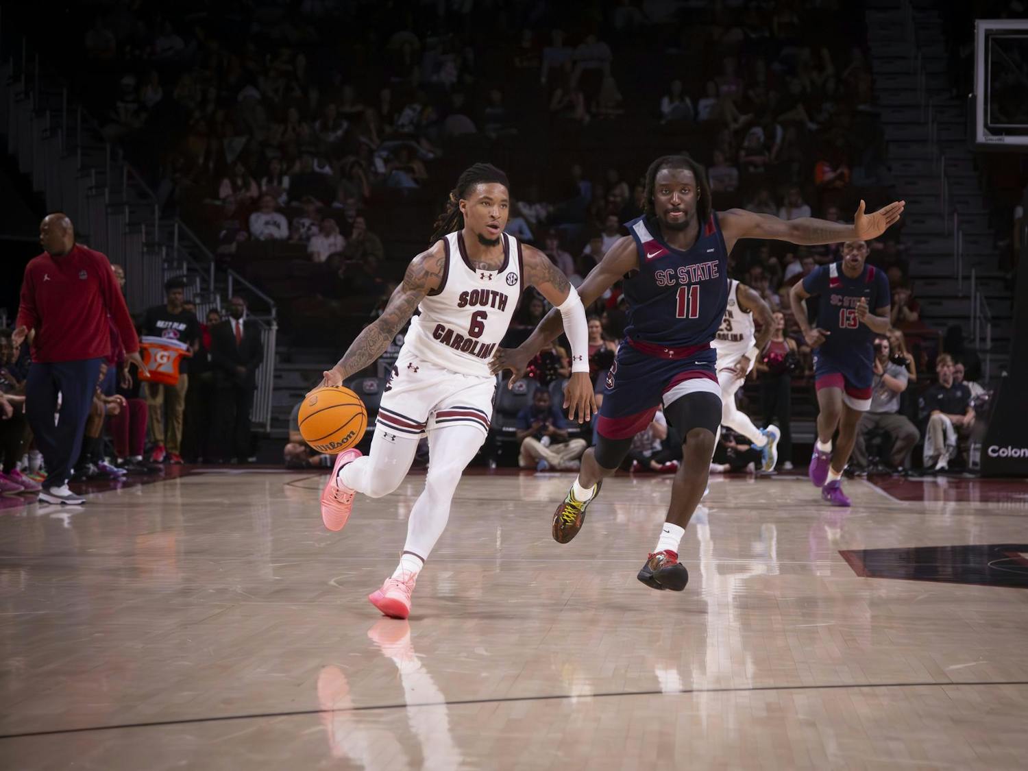 FILE - Senior guard Jamarii Thomas dribbles the ball past a South Carolina State University defender at Colonial Life Arena on Nov. 8, 2024.