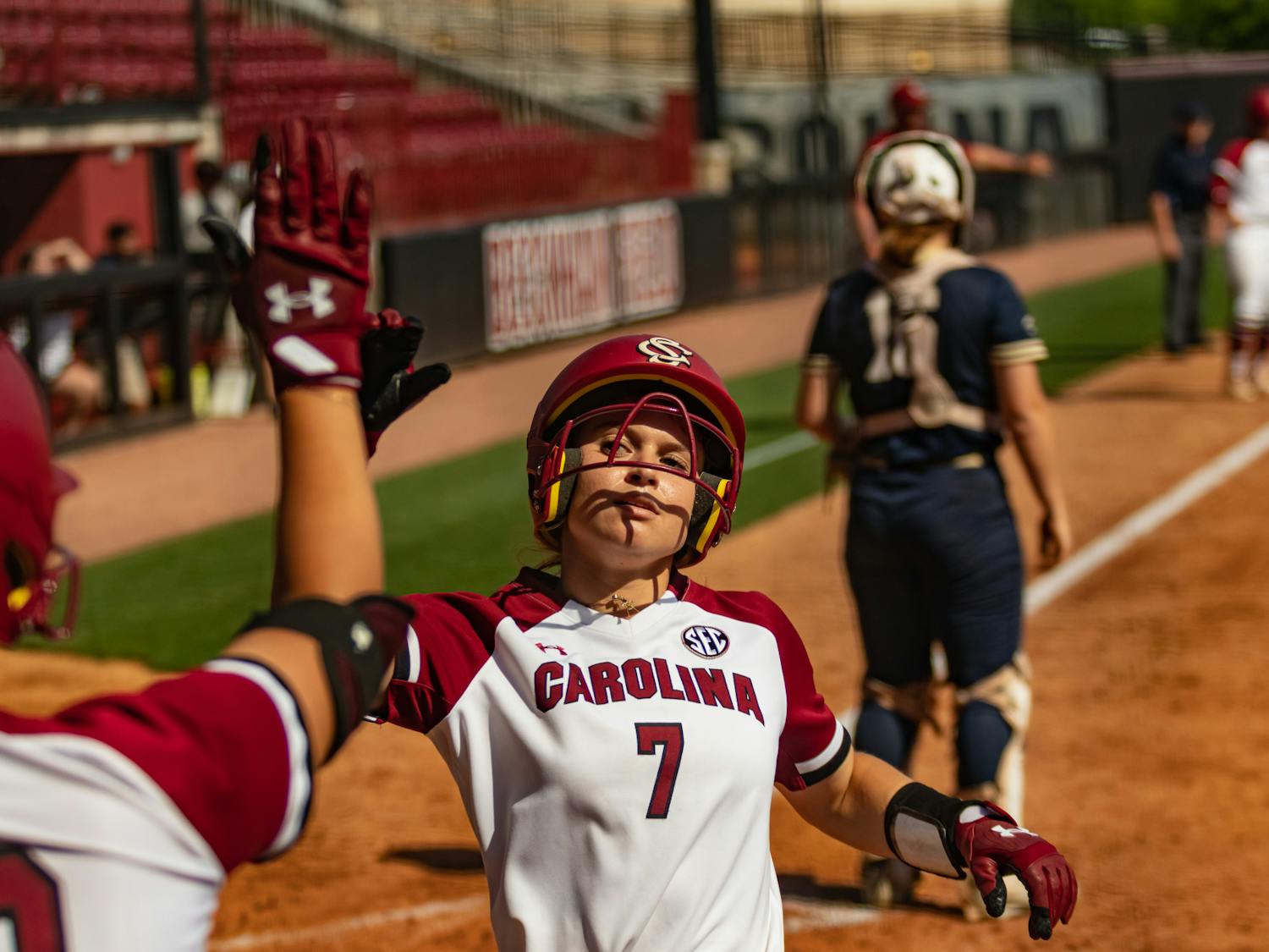 Sophomore catcher and infielder Giulia Desiderio scores and receives a high five from a teammate during the first game against Charleston Southern at Beckham Field on April 19, 2023. This was one of five runs that the Gamecocks scored against the Buccaneers, winning 5-0. &nbsp;