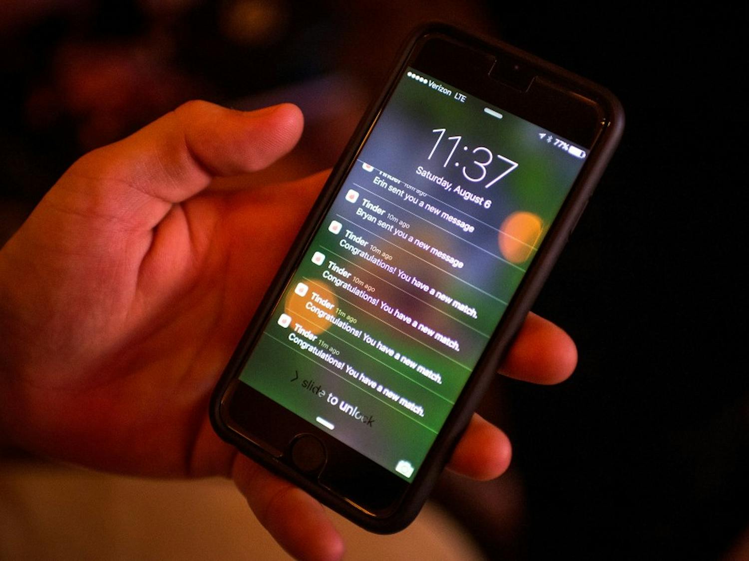 Michael Durand, of Rockford, Minn., checks his Tinder notifications late Saturday night, Aug. 6, 2016 at Cowboy Jack's in downtown Minneapolis. (Aaron Lavinsky/Minneapolis Star Tribune/TNS)
