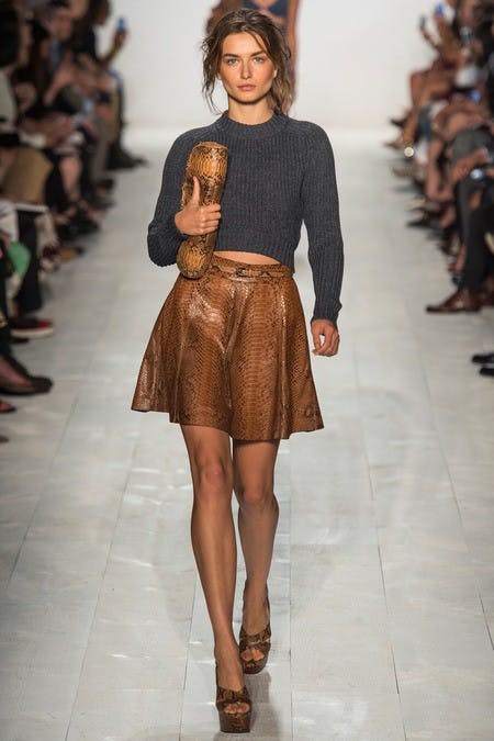	The high-waisted skirt balances out the cropped sweater at Michael Kors.
