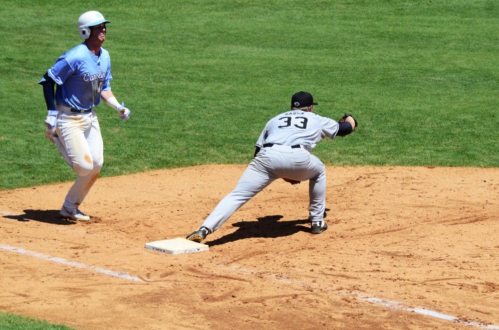Gamecocks first baseman Kyle Martin tags out a runner at first.