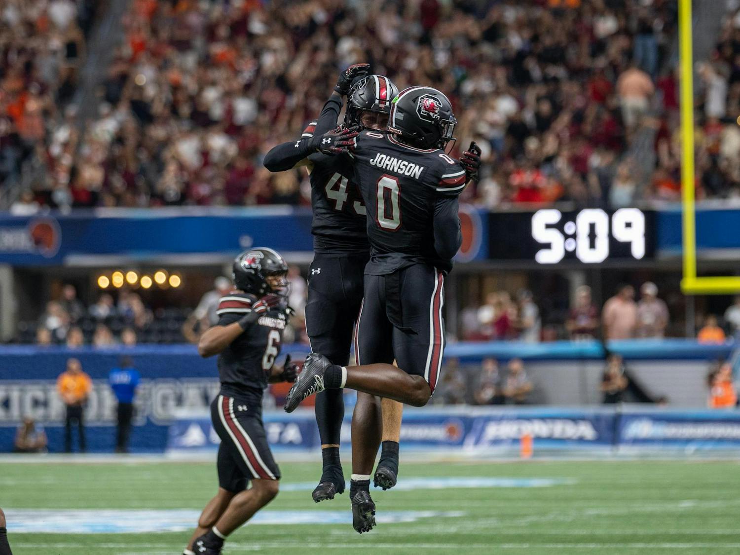 FILE — Redshirt senior linebacker Colin Bryant (left) and sophomore linebacker Fred "JayR" Johnson (right) celebrate after Johnson intercepted a pass from Virginia Tech on Aug. 31, 2025, at Mercedes-Benz Stadium. Johnson recorded six solo tackles, one interception and one broken-up pass for the Gamecocks against the Hokies.