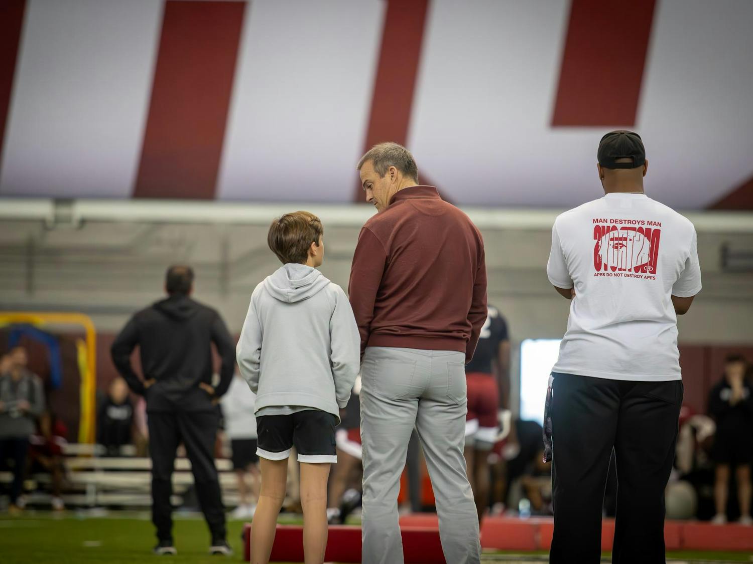 University of South Carolina football head coach Shane Beamer stands with his son at the Gamecock NFL Pro Day on March 18, 2025. Twenty-five former Gamecocks participated in workouts such as the broad jump, 40-yard dash, short shuttle and three-cone drills.