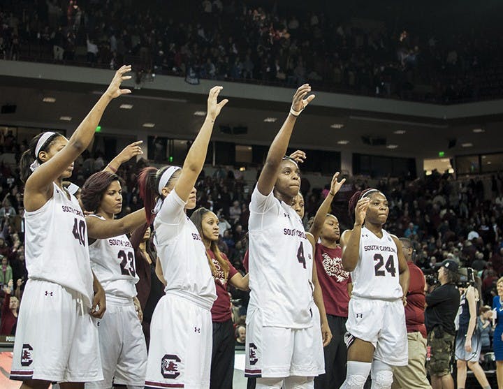 The team stands together while Forever to Thee plays. The Gamecock's finished strong, losing by only 12 points. 