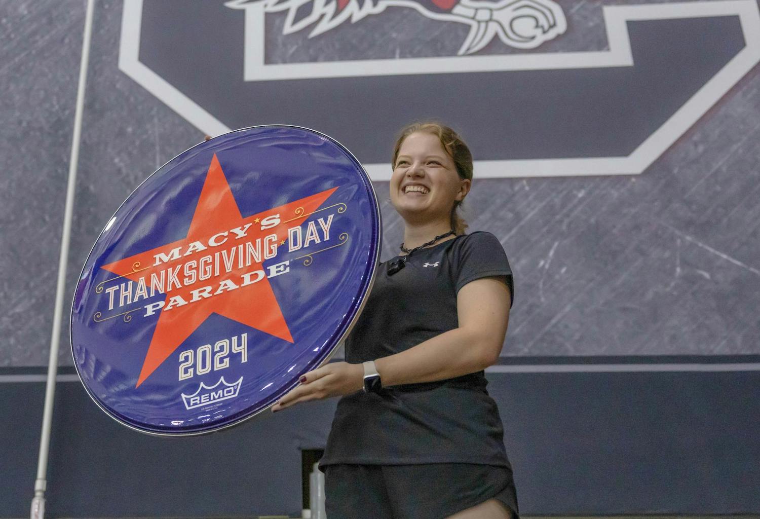 Fourth-year public health student Meredith Rhodes holds a 2024 Macy's Thanksgiving Day Parade drumhead. The Carolina Band will perform during the parade on Nov. 28, 2024.