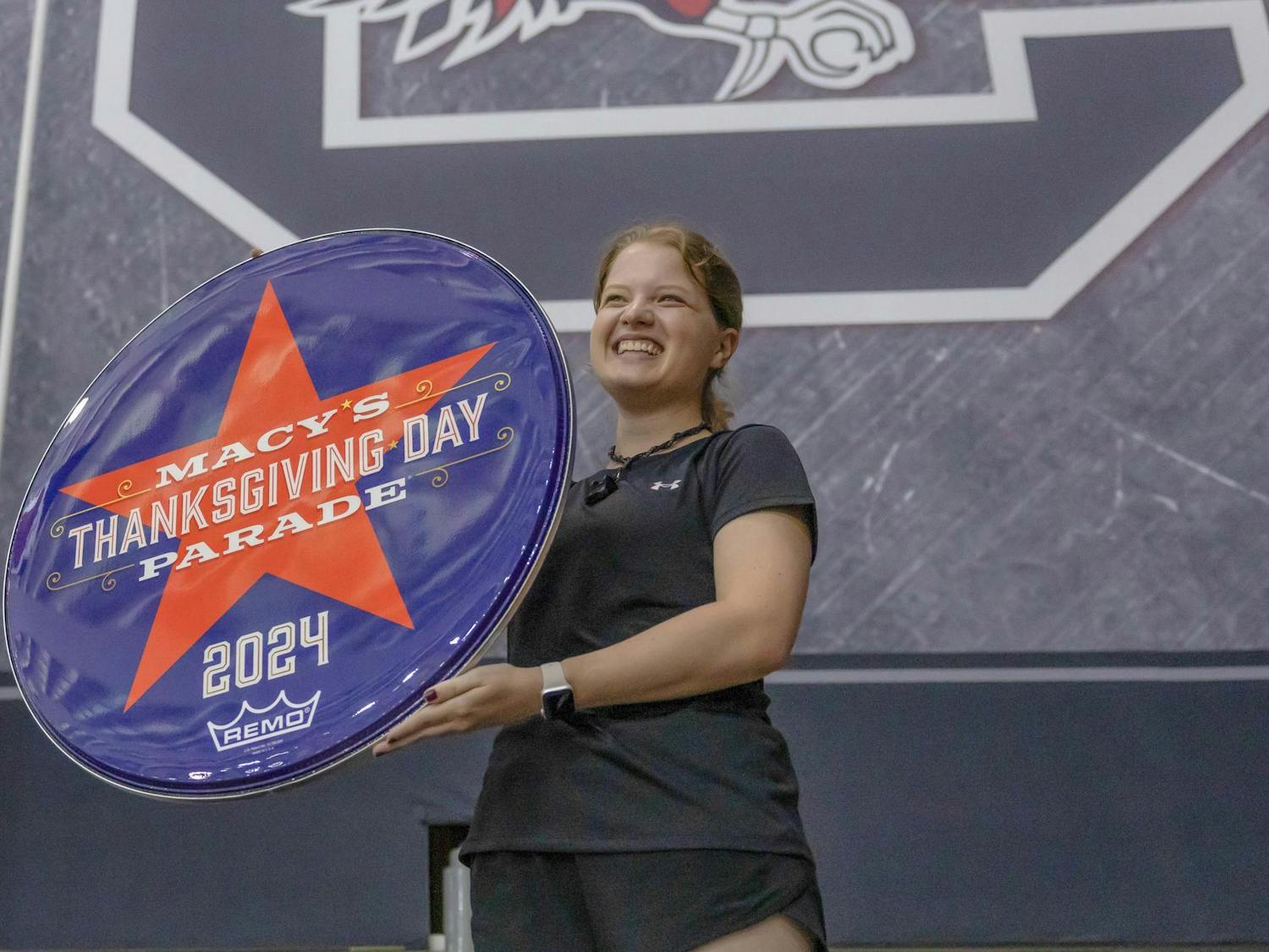 Fourth-year public health student Meredith Rhodes holds a 2024 Macy's Thanksgiving Day Parade drumhead. The Carolina Band will perform during the parade on Nov. 28, 2024.
