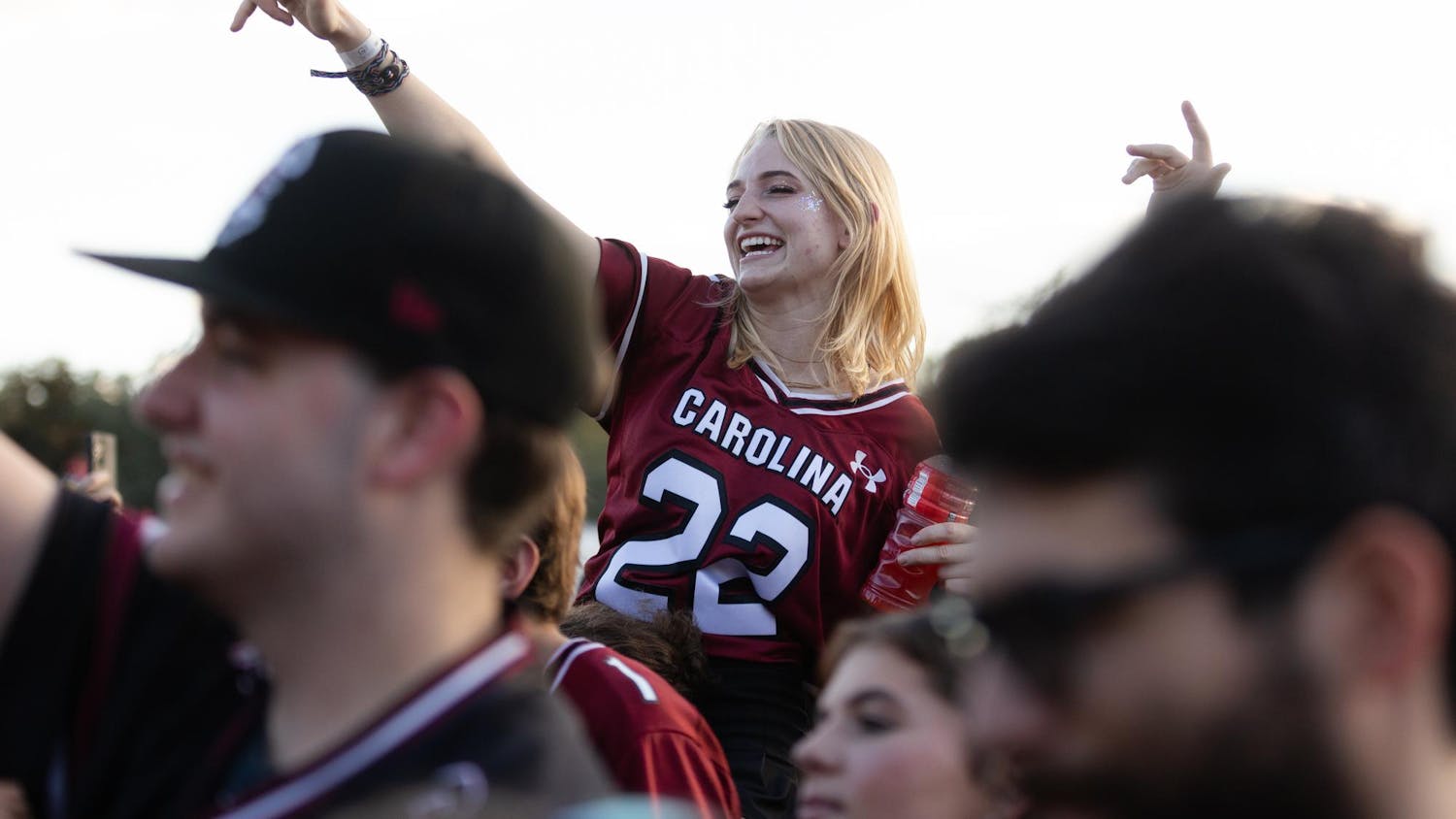 A Gamecock fan moves her arms to the music while at a pre-game Darude concert in Gamecock Park. The Gamecocks went on to defeat the Wildcats 17-14.