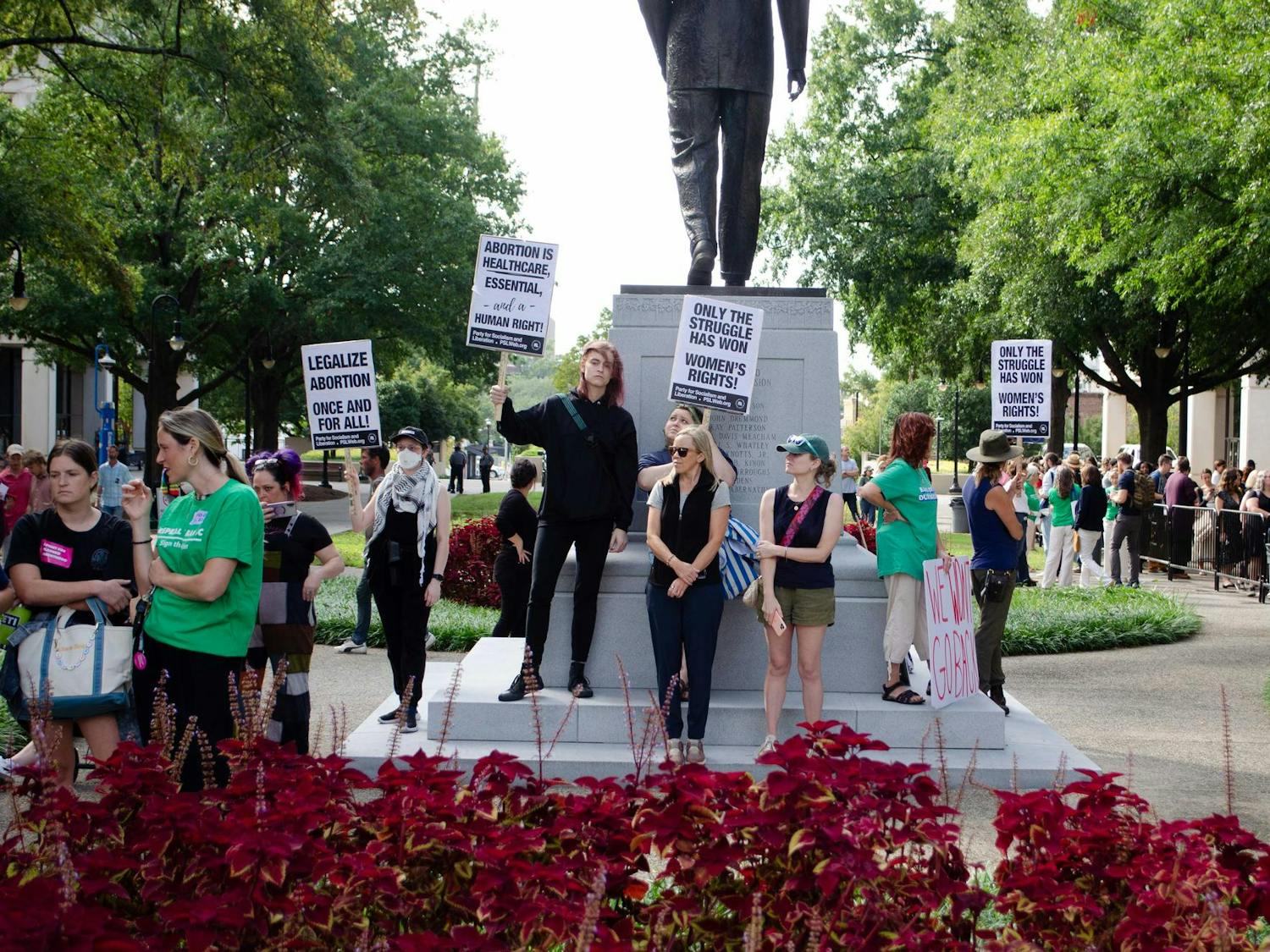Protestors against Senate Bill 323 wave signs in support of abortion rights at the South Carolina State Capitol on Oct. 1, 2025. Their signs also voice support for the Party for Socialism and Liberation.