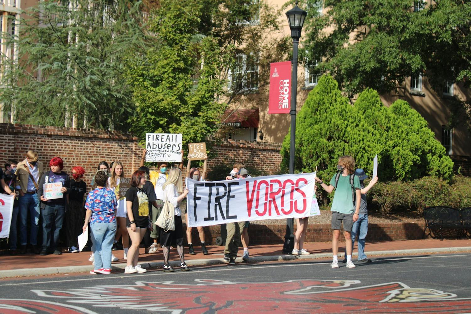 鶹С򽴫ý Student protesters in front of Russell House on Greene Street in protest to fire Voros and others accused of sexual misconduct. Two people are holding a sign that said "Fire Voros."&nbsp;