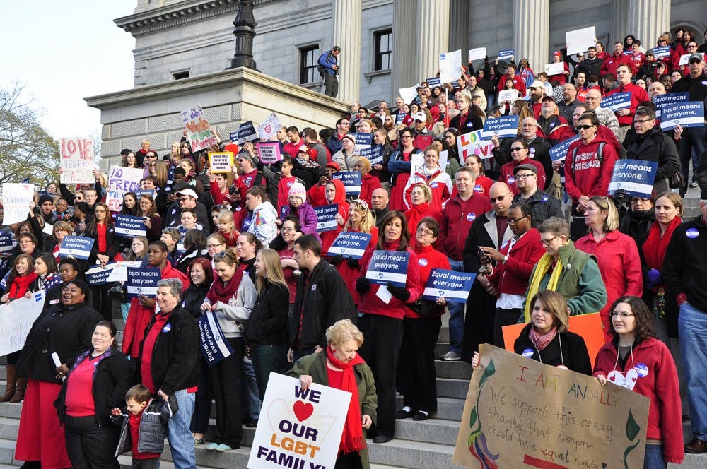 A large crowd of same-sex marriage supporters stands on the steps of the Statehouse Tuesday.