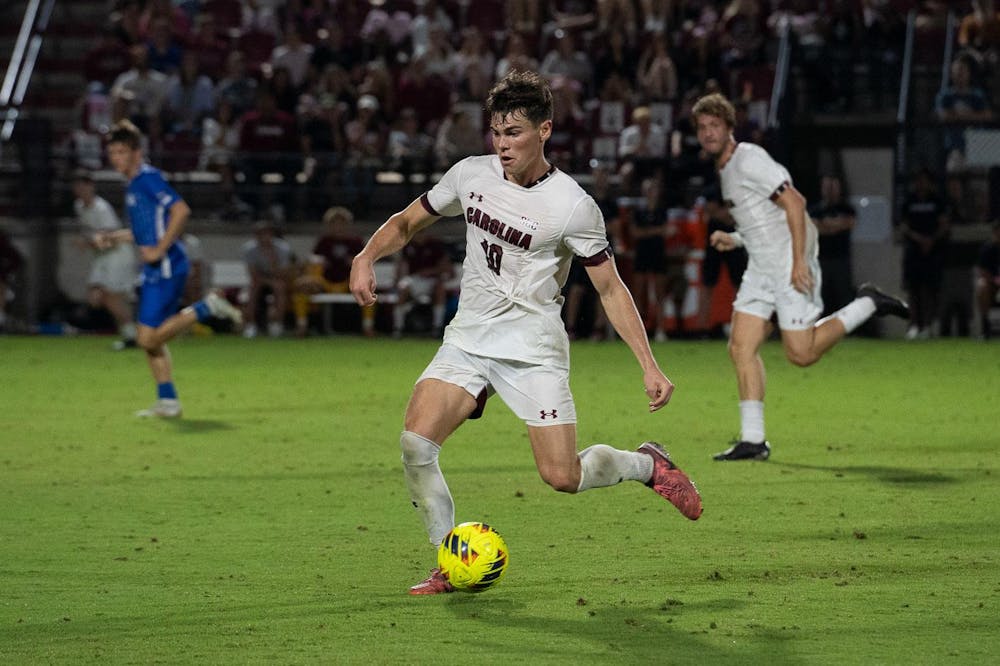 <p>Junior midfielder Ethan Ballek hurries to pass the ball to his teammate during South Carolina's matchup against Kentucky at Stone Stadium on Oct. 4, 2024. The Gamecocks are now 6-2-2 overall after the team's 2-0 loss to the Wildcats.</p>