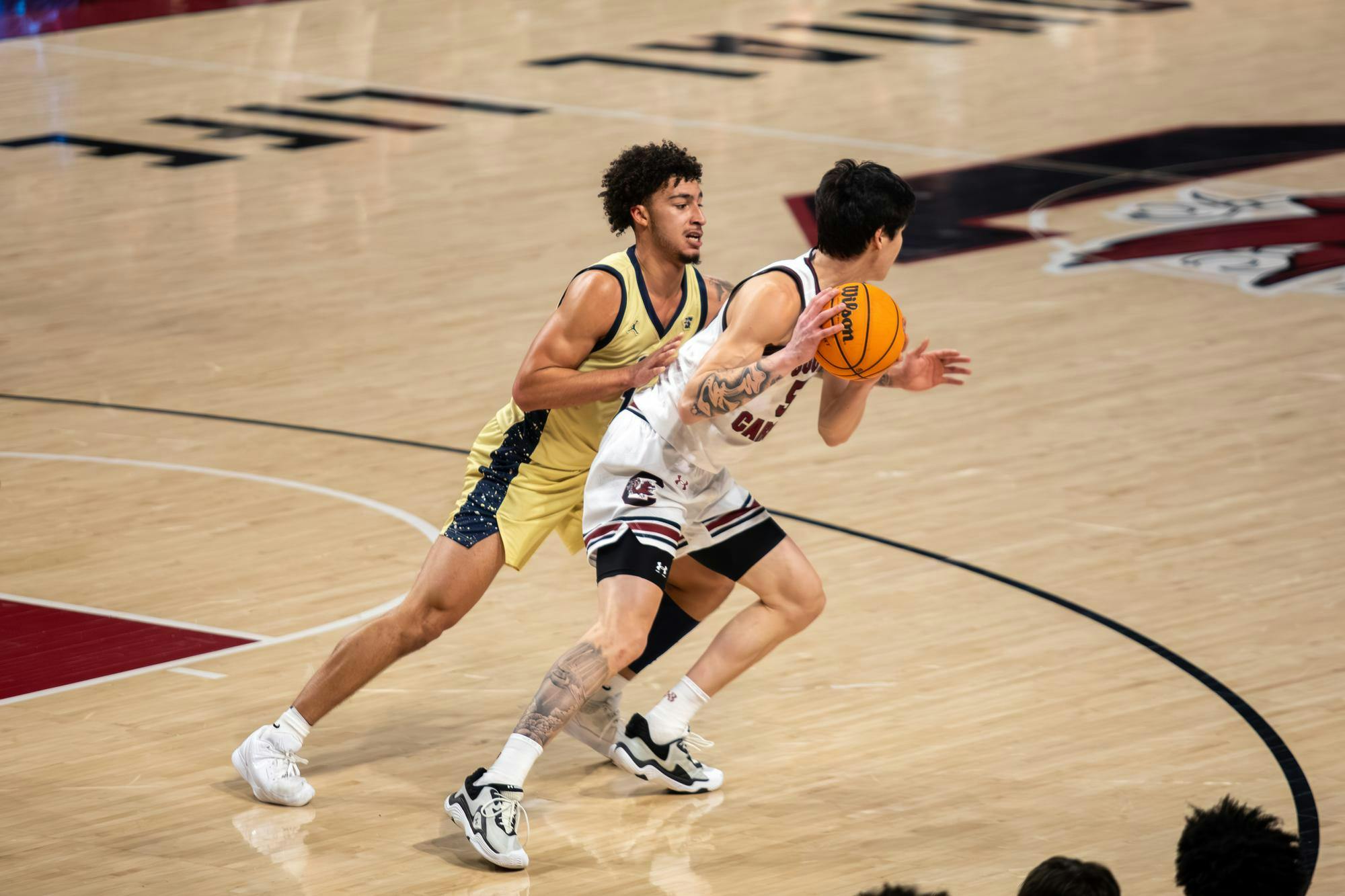 Senior guard Mike Sharavjamts maneuvers the ball around an opposing player during the game against Charleston Southern on Nov. 28, 2025. Sharavjamts made a total of eight rebounds and seven assists.