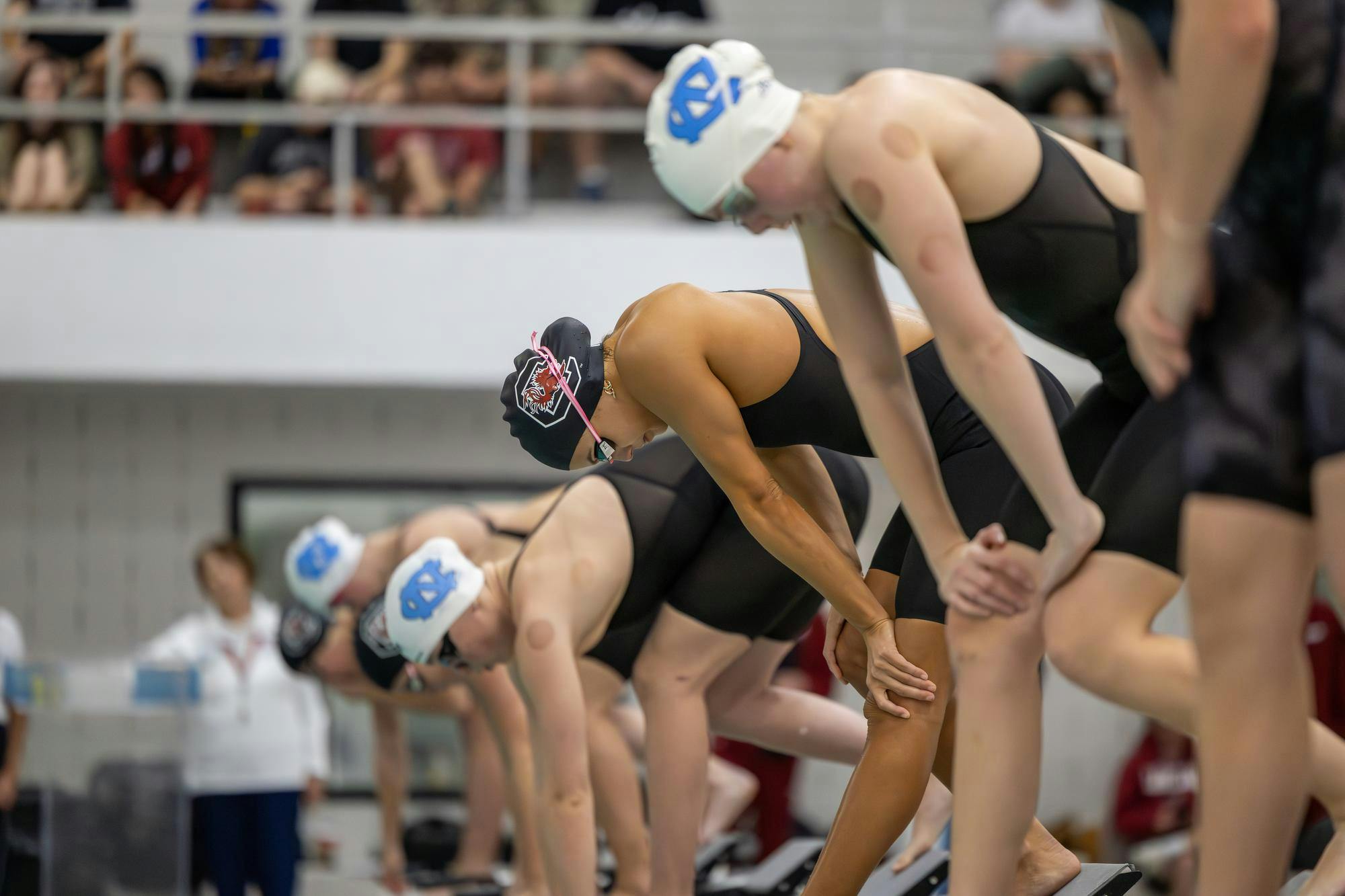 Freshman freestyle swimmer Sofia Luper (center) prepares to compete in the women’s 200-yard freestyle event against North Carolina on Nov. 7, 2025, at the Carolina Natatorium. Luper finished in fourth place with a time of one minute, 48.84 seconds.