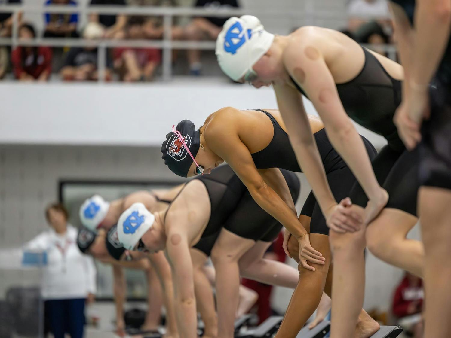 Freshman freestyle swimmer Sofia Luper (center) prepares to compete in the women’s 200-yard freestyle event against North Carolina on Nov. 7, 2025, at the Carolina Natatorium. Luper finished in fourth place with a time of one minute, 48.84 seconds.