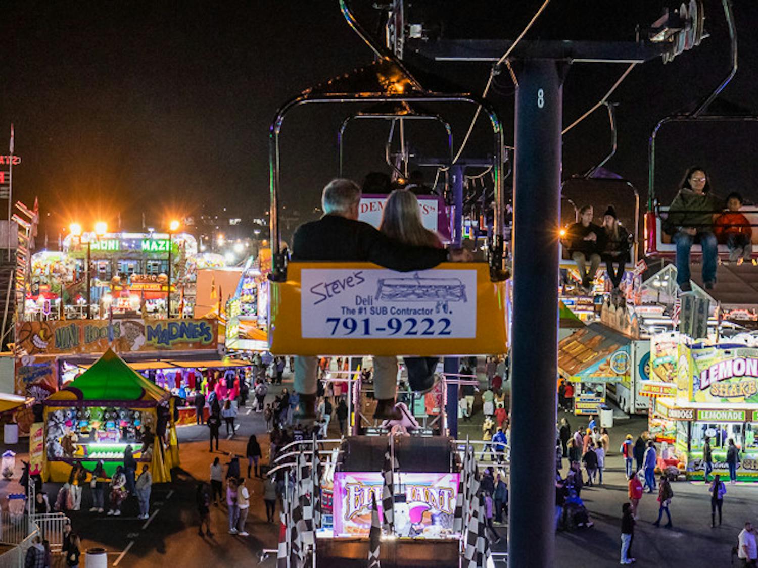 An elderly couple takes in the many lights, sounds and smells from one of the Skyride gondolas at the South Carolina State Fair on Oct. 20, 2022. The state fair took place in Columbia, S.C. from Oct. 12-23, 2022.